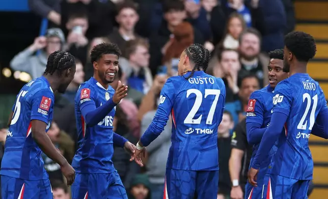 Chelsea's Andrey Santos, second left, celebrates after scoring his side's fifth goal during the English FA Cup quarterfinal soccer match between Chelsea and Port Vale in London, England, Saturday, April 4, 2026. (AP Photo/Ian Walton)