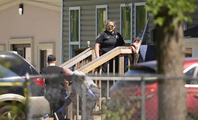 Police enter a house in Shreveport, La., that is one of the locations tied to a mass shooting Sunday, April 19, 2026. (AP Photo/Gerald Herbert)