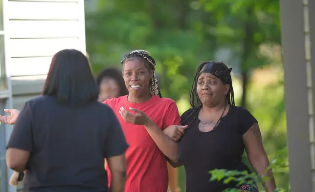 People are consoled outside the scene of a mass shooting, Sunday, April 19, 2026, in Shreveport, La. (AP Photo/Gerald Herbert)