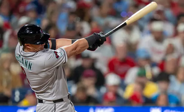 Arizona Diamondbacks' James McCann hits a a two-run double during the fifth inning of a baseball game against the Philadelphia Phillies, Friday, April 10, 2026, in Philadelphia. (AP Photo/Chris Szagola)