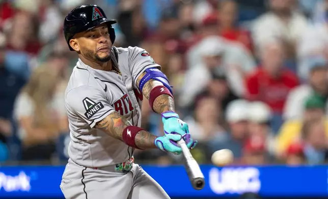 Arizona Diamondbacks' Ketel Marte hits a two-run single during the fifth inning of a baseball game against the Philadelphia Phillies, Friday, April 10, 2026, in Philadelphia. (AP Photo/Chris Szagola)
