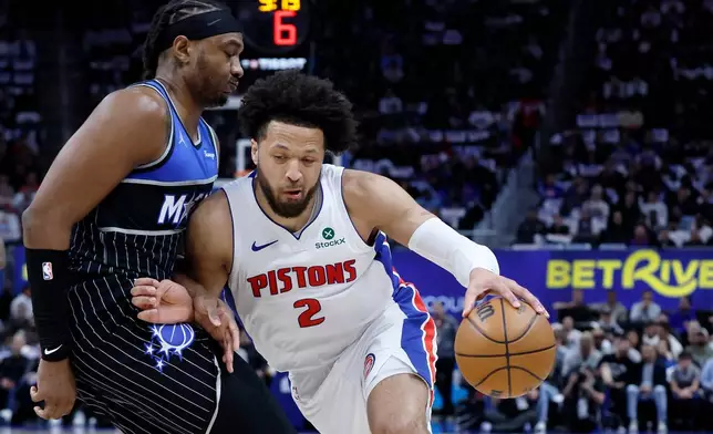 Detroit Pistons guard Cade Cunningham (2) drives against Orlando Magic center Wendell Carter Jr. (34) during the first half in Game 5 of a first-round NBA basketball playoffs series Wednesday, April 29, 2026, in Detroit. (AP Photo/Duane Burleson)