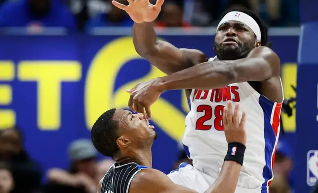 Detroit Pistons forward Isaiah Stewart (28) rejects a shot by Orlando Magic forward Jamal Cain (8) during the first half in Game 5 of a first-round NBA basketball playoffs series Wednesday, April 29, 2026, in Detroit. (AP Photo/Duane Burleson)
