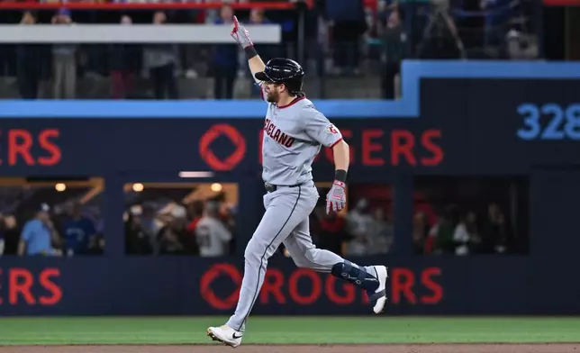 Cleveland Guardians' Daniel Schneemann (10) runs the bases after hitting a solo home run against the Toronto Blue Jays in first inning of a baseball game in Toronto on Friday, April 24, 2026. (Jon Blacker/The Canadian Press via AP)