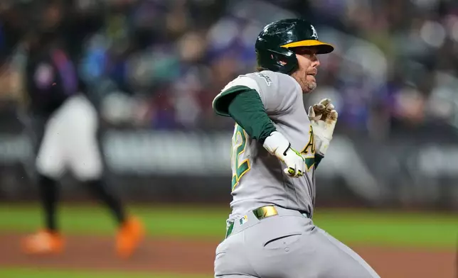 Athletics' Jeff McNeil (22) runs to second base for a double during the fourth inning of a baseball game against the New York Mets Friday, April 10, 2026, in New York. (AP Photo/Frank Franklin II)