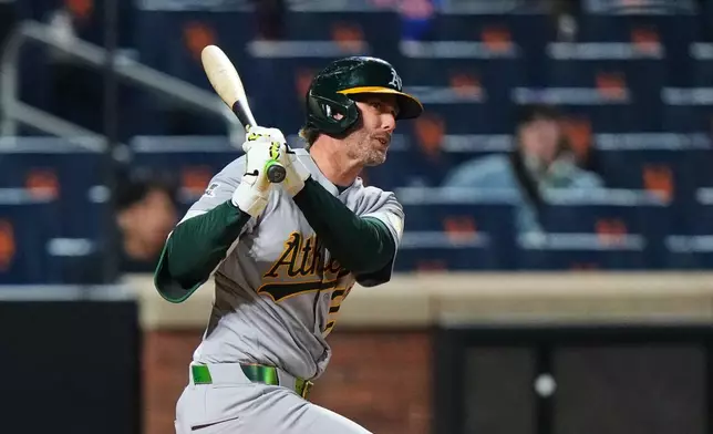 Athletics' Jeff McNeil follows through on a double during the fourth inning of a baseball game against the New York Mets Friday, April 10, 2026, in New York. (AP Photo/Frank Franklin II)