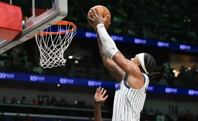 Orlando Magic forward Paolo Banchero (5) dunks in the second half against the New Orleans Pelicans in an NBA basketball game in New Orleans, Sunday, April 5, 2026. (AP Photo/Ella Hall)