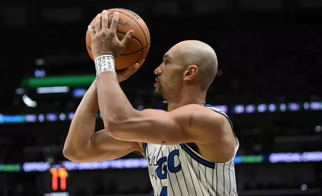 Orlando Magic guard Jalen Suggs (4) shoots in the second half against the New Orleans Pelicans in an NBA basketball game in New Orleans, Sunday, April 5, 2026. (AP Photo/Ella Hall)