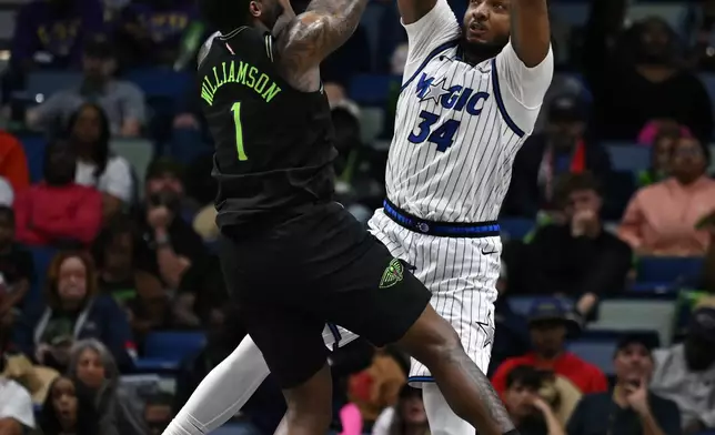 Orlando Magic center-forward Wendell Carter Jr. (34) blocks New Orleans Pelicans forward Zion Williamson (1) in the second half of an NBA basketball game in New Orleans, Sunday, April 5, 2026. (AP Photo/Ella Hall)