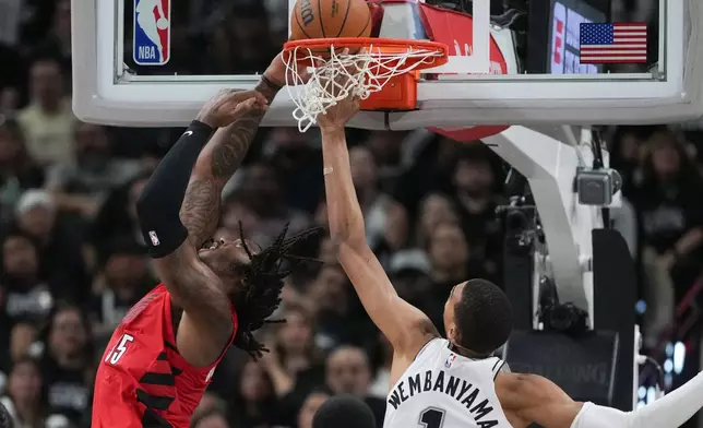 Portland Trail Blazers center/forward Robert Williams III (35) scores past San Antonio Spurs forward/center Victor Wembanyama (1) during the second half in Game 5 of a first-round NBA playoffs basketball series in San Antonio, Tuesday, April 28, 2026. (AP Photo/Eric Gay)