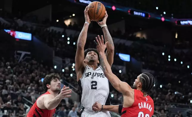San Antonio Spurs guard Dylan Harper (2) goes to the basket as Portland Trail Blazers forward Deni Avdija, left, and Portland Trail Blazers forward Toumani Camara (33) defend during the second half in Game 5 of a first-round NBA playoffs basketball series in San Antonio, Tuesday, April 28, 2026. (AP Photo/Eric Gay)