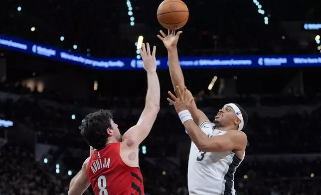 San Antonio Spurs forward/guard Keldon Johnson (3) goes to the basket as Portland Trail Blazers forward Deni Avdija (8) defends during the second half in Game 5 of a first-round NBA playoffs basketball series in San Antonio, Tuesday, April 28, 2026. (AP Photo/Eric Gay)