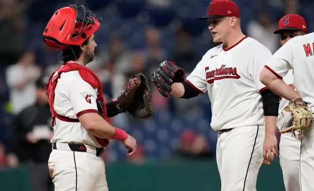 Cleveland Guardians pitcher Parker Messick, right, bumps gloves with catcher Austin Hedges, left, as he is taken out of the game in the ninth inning of a baseball game against tghe Baltimore Orioles in Cleveland, Thursday, April 16, 2026. (AP Photo/Sue Ogrocki)