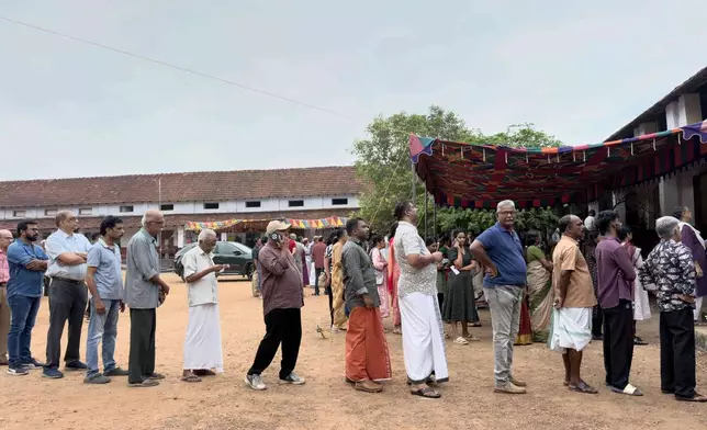 People queue up to vote outside a polling booth during the Kerala state election in Kochi, India, Thursday, April 9, 2026. (AP Photo/ R S Iyer)