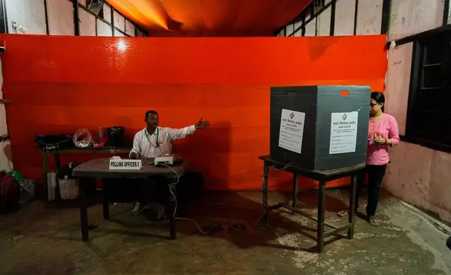 A woman casts her vote at a polling center during the state election in Guwahati, India, Thursday, April 9, 2026. (AP Photo/Anupam Nath)
