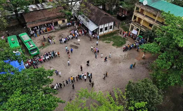 People stand in queue to cast their votes at a polling center during the state election in Guwahati, India, Thursday, April 9, 2026. (AP Photo/Anupam Nath)