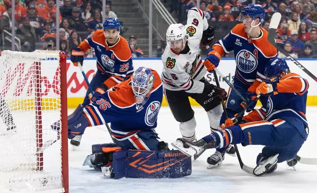 Chicago Blackhawks' Sam Rinzel (6) watches the puck go in past Edmonton Oilers goalie Tristan Jarry (35) during third-period NHL hockey game action in Edmonton, Alberta, Thursday, April 2, 2026. (Jason Franson/The Canadian Press via AP)