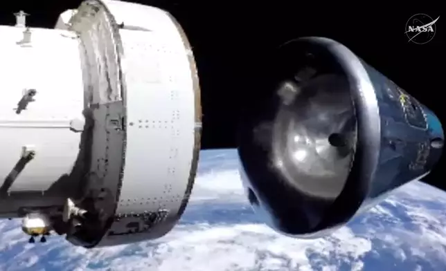 In this image from video provided by NASA, the Artemis II Orion capsule, right, separates from the service module above the Earth in preparation for splash down in the Pacific Ocean. (NASA via AP)