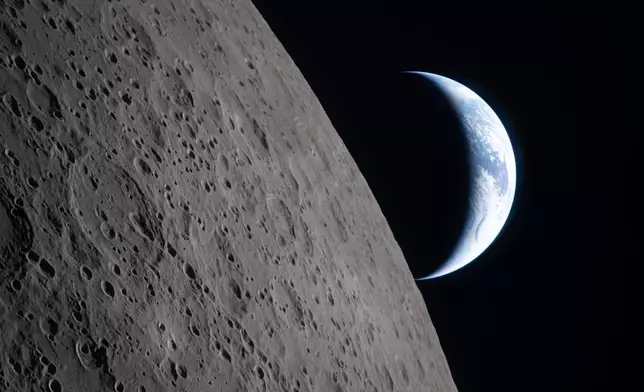 In this image provided by NASA, the Artemis II crew captured this view as the Earth sets behind the Moon during a lunar flyby, Monday, April 6, 2026. (NASA via AP)