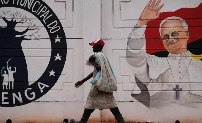 A man walks past a mural of Pope Leo XIV in Luanda, South Africa, Thursday, April 16, 2026. (AP Photo/Themba Hadebe)