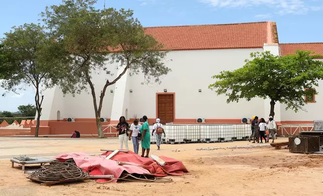 People walk by the Church of Our Lady of Muxima in Muxima, Angola, Saturday, April 11, 2026 which Pope Leo XIV will visit during his 11-day pastoral visit to Africa. (AP Photo)