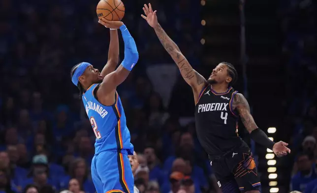 Oklahoma City Thunder guard Shai Gilgeous-Alexander (2) looks to shoot over Phoenix Suns guard Jalen Green (4) during the first half in Game 1 of a first-round NBA playoffs basketball series Sunday, April 19, 2026, in Oklahoma City. (AP Photo/Nate Billings)