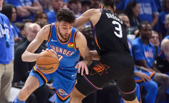 Oklahoma City Thunder center Chet Holmgren, left, drives against Phoenix Suns forward Dillon Brooks (3) during the first half in Game 1 of a first-round NBA playoffs basketball series Sunday, April 19, 2026, in Oklahoma City. (AP Photo/Nate Billings)