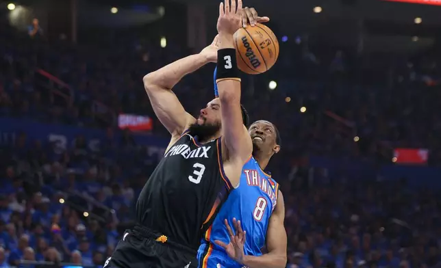 Oklahoma City Thunder guard Jalen Williams (8) blocks a shot by Phoenix Suns forward Dillon Brooks (3) during the first half in Game 1 of a first-round NBA playoffs basketball series Sunday, April 19, 2026, in Oklahoma City. (AP Photo/Nate Billings)