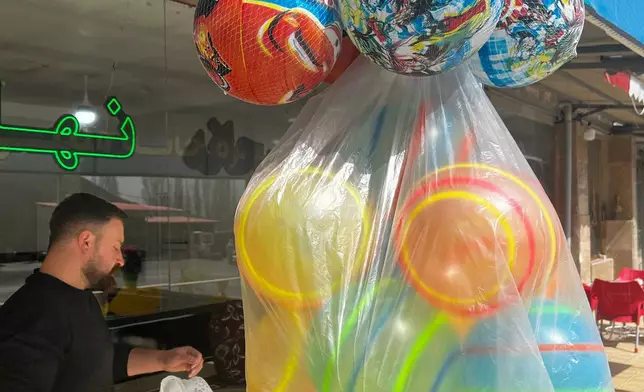 A waiter serves customers at a roadside restaurant near Sinur, Iran, Saturday, April 4, 2026. (AP Photo/Francisco Seco)