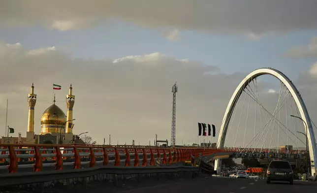 Cars drive past the Grand Husseiniyah mosque, left, in Zanjan, Iran, Saturday, April 4, 2026. (AP Photo/Francisco Seco)