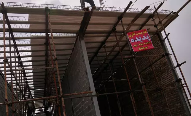 Construction workers build what appears to be a roadside shop in Marand, Iran, Saturday, April 4, 2026. (AP Photo/Francisco Seco)