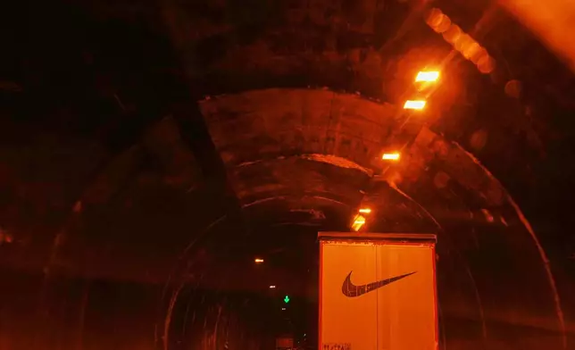 A truck with a Nike logo across its rear doors drives through a tunnel toward Tehran between Tabriz and Zanjan, Iran, Saturday, April 4, 2026. (AP Photo/Francisco Seco)