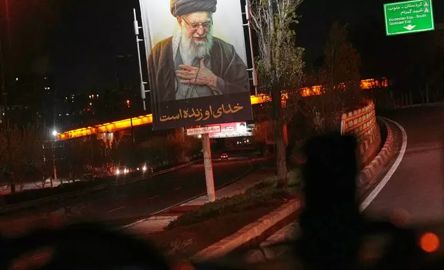 A billboard showing Iran's slain Supreme Leader Ayatollah Ali Khamenei overlooks traffic on a highway entering Tehran, Iran, Saturday, April 4, 2026. (AP Photo/Francisco Seco)