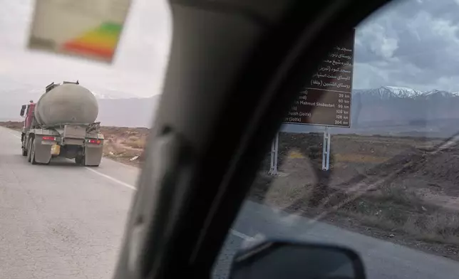 Backdropped by snow-covered mountains, a truck drives along a highway between Khoy and Marand, Iran, Saturday, April 4, 2026. (AP Photo/Francisco Seco)