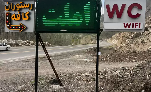 A sign points toward a roadside restaurant near Sinur, Iran, Saturday, April 4, 2026. (AP Photo/Francisco Seco)