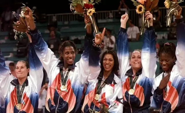FILE - United States' women's basketball team members, fromleft, from left are: Jennifer Azzi, Lisa Leslie, Carla McGhee, Katy Steding and Sheryl Swoopes, wear their gold medals during medal ceremonies in basketball at the Centennial Summer Olympic Games in Atlanta Sunday, August 4, 1996. (AP Photo/Susan Ragan, File)