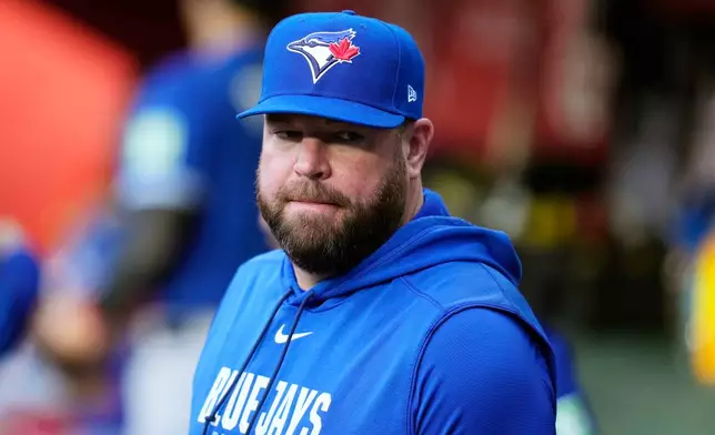 Toronto Blue Jays manager John Schneider pauses in the team dugout prior to a baseball game against the Arizona Diamondbacks, Saturday, April 18, 2026, in Phoenix. (AP Photo/Ross D. Franklin)