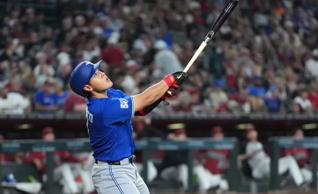 Toronto Blue Jays' Kazuma Okamoto, of Japan, fouls off a pitch against the Arizona Diamondbacks during the seventh inning of a baseball game, Sunday, April 19, 2026, in Phoenix. (AP Photo/Ross D. Franklin)
