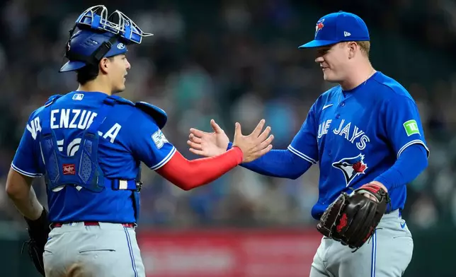 Toronto Blue Jays relief pitcher Braydon Fisher, right, shakes hands with Blue Jays catcher Brandon Valenzuela after the final out in the ninth inning of a baseball game against the Arizona Diamondbacks, Sunday, April 19, 2026, in Phoenix. (AP Photo/Ross D. Franklin)