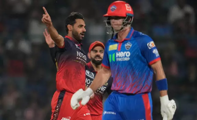 Royal Challengers Bengaluru's Bhuvneshwar Kumar, left, celebrates the wicket of Delhi Capitals' Tristan Stubbs, right, during the Indian Premier League cricket match between Delhi Capitals and Royal Challengers Bengaluru in Delhi, India, Monday, April 27, 2026. (AP Photo/Manish Swarup)