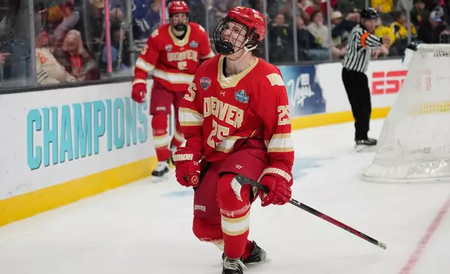 Denver forward Clarke Caswell (25) celebrates after scoring against Michigan in the third period of a semifinal game of the NCAA Frozen Four men's college hockey tournament Thursday, April 9, 2026, in Las Vegas. (AP Photo/John Locher)