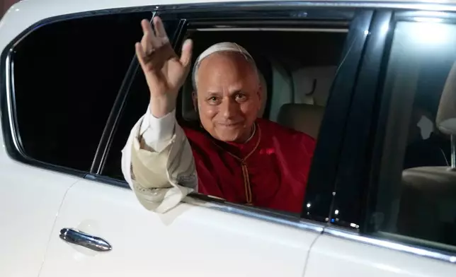 Pope Leo XIV waves to the crowd at the Parish of Our Lady of Fatima after meeting with bishops, priests, consecrated men and women, and pastoral workers in Luanda, Angola, Monday, April 20, 2026. (AP Photo/Themba Hadebe)