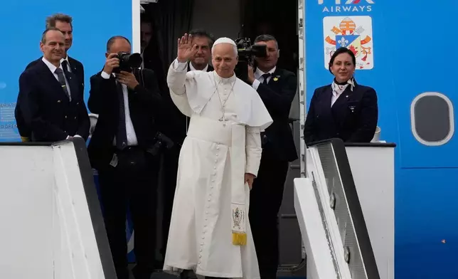 Pope Leo XIV waves as he departs for Equatorial Guinea, in Luanda, Angola, Tuesday, April 21, 2026. (AP Photo/Themba Hadebe)