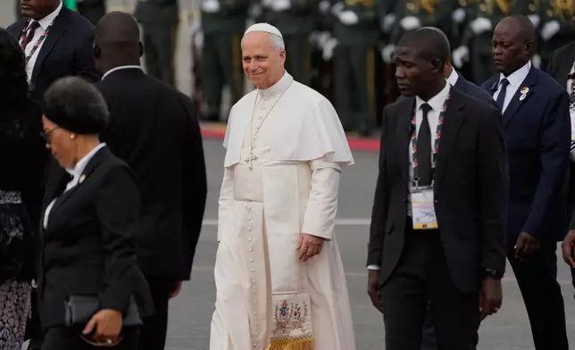 Pope Leo XIV walks prior to his departure for Equatorial Guinea, in Luanda, Angola, Tuesday, April 21, 2026. (AP Photo/Themba Hadebe)