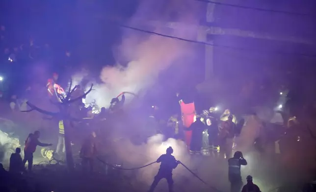 Firefighters and rescue workers work at the site of Israeli airstrikes, in Beirut, Lebanon, Wednesday, April 1, 2026. (AP Photo/Hussein Malla)