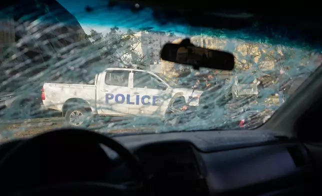 A police vehicle is seen through a shattered windshield at the site of an Israeli strike in Beirut, Lebanon, Wednesday, April 1, 2026. (AP Photo/Hassan Ammar)