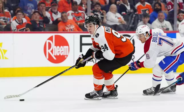 Philadelphia Flyers' Porter Martone skates the puck past Montréal Canadiens' Zachary Bolduc (76) during the second period of an NHL hockey game, Tuesday, April 14, 2026, in Philadelphia. (AP Photo/Derik Hamilton)