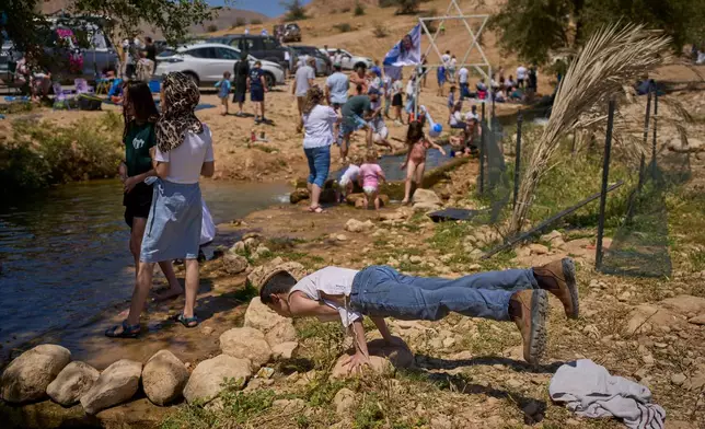 Israelis enjoy a day at a spring in Auja, in the Jordan Valley, during Israel's Independence Day on Wednesday, April 22, 2026, in the occupied West Bank. (AP Photo/Ohad Zwigenberg)