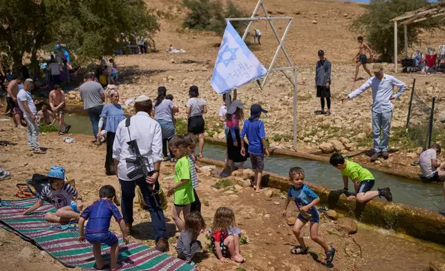 Israelis enjoy a day at a spring in Auja, in the Jordan Valley, during Israel's Independence Day on Wednesday, April 22, 2026, in the occupied West Bank. (AP Photo/Ohad Zwigenberg)