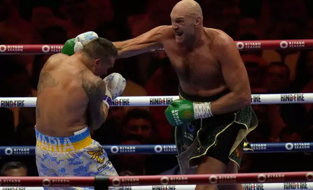 FILE - Britain's Tyson Fury, right, punches Ukraine's Oleksandr Usyk during their undisputed heavyweight world championship boxing fight at the Kingdom Arena in Riyadh, Saudi Arabia, on May 19, 2024. (AP Photo/Francisco Seco, File)